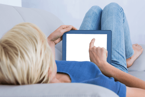 blonde woman relaxing using transparent tablet on couch - Download Free Stock Videos Pikwizard.com