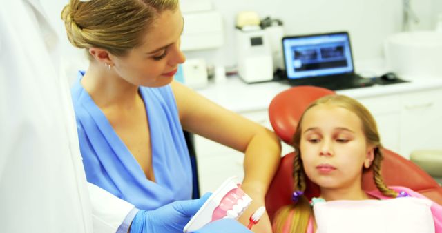 Female Dentist Explaining Dental Care to Young Girl in Clinic - Download Free Stock Images Pikwizard.com