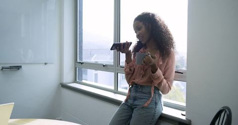 Professional Woman Multitasking in Modern Office Environment