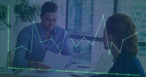 Colleagues Analyzing Data Chart in Modern Office Setting