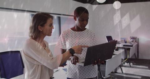 Two Women Engaged in Collaborative Work in Modern Office