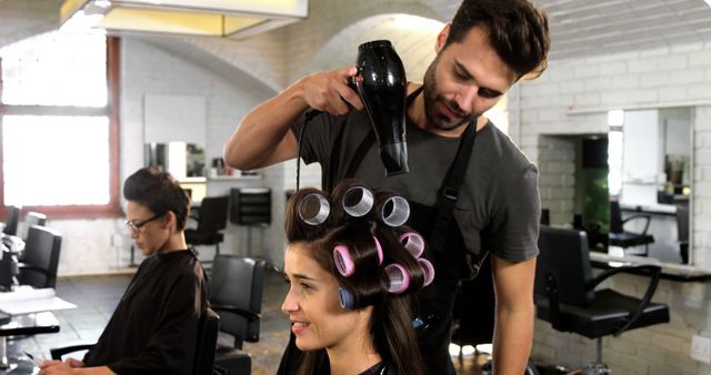 Hairdresser Styling Woman's Hair with Curlers in Salon - Download Free Stock Images Pikwizard.com