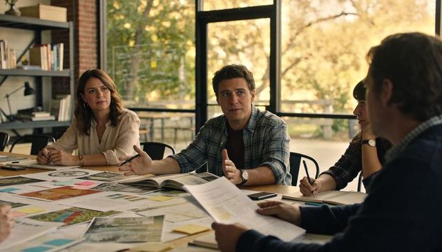 Leading man presenting collaborative planning with maps, documents and team discussion