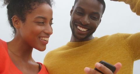 Cheerful Couple Enjoying Smartphone Together