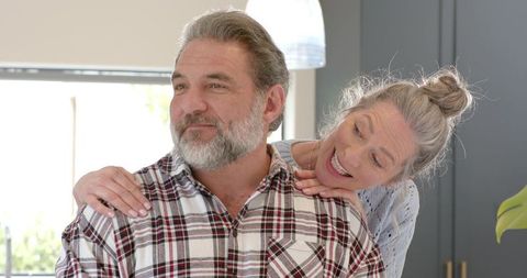 Senior Couple Embracing in Contemporary Kitchen Setting