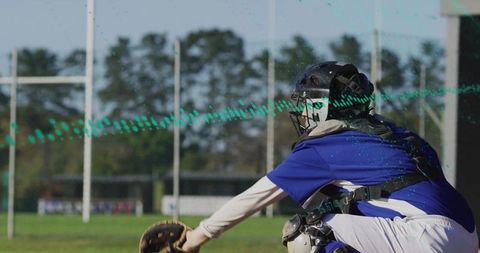Female catcher in action on baseball field during a sunny day