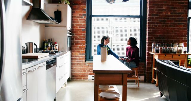 Friends Chatting Over Tea in a Cozy Industrial Kitchen - Download Free Stock Images Pikwizard.com