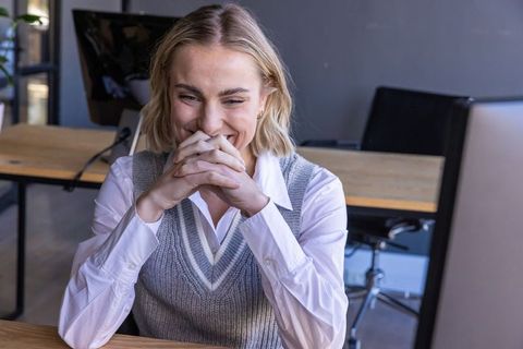 Smiling businesswoman enjoying success in modern office environment