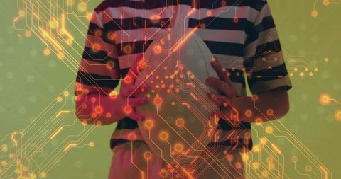 Woman holding rugby ball with futuristic circuitry overlay