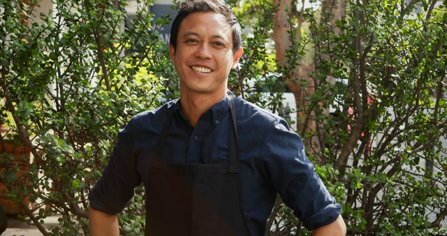 Smiling Male Chef in Black Apron Standing Outdoors - Download Free Stock Images Pikwizard.com