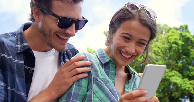 Happy Couple Using Smartphone Outdoors on Sunny Day - Download Free Stock Images Pikwizard.com