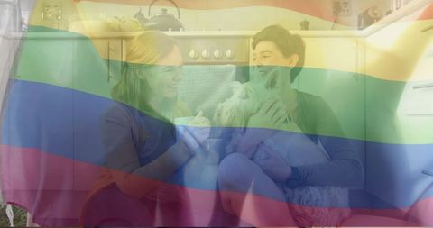 Lesbian Couple and Dog with Transparent Pride Flag in Cozy Kitchen