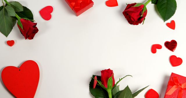 Red roses, gift boxes and heart shape of confetti on white surface in circle formation. Valentines day concept 4k