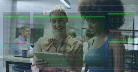 Women collaborating on tablet in modern office with code and data visualization overlay