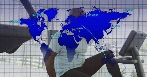 Man pedaling stationary bike with blue world map overlay showing global fitness data