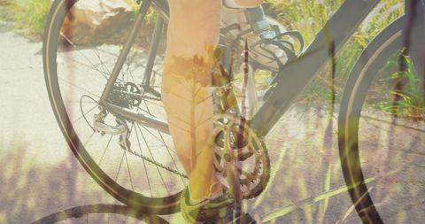 Caucasian Woman Cycling Through Nature Overlaid with Grass Shape