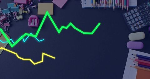 Neon graph lines floating over dark desk colorful stationery business data concept