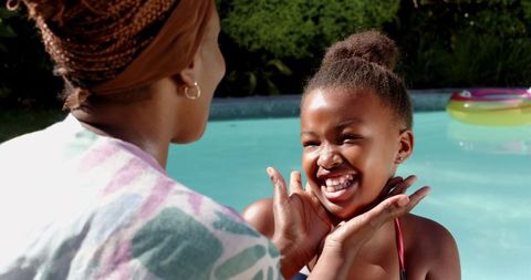 Mother and Daughter Sharing Joyful Moment by Swimming Pool