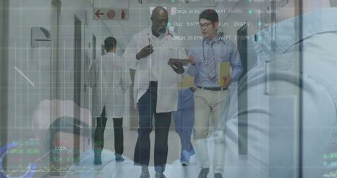 Medical Team Discussing Diagnostic Data in Hospital Corridor