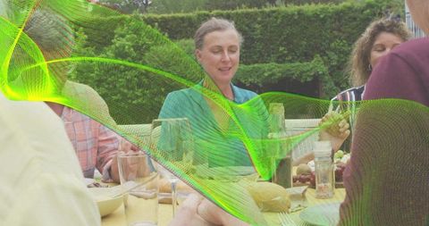 Pausing at Garden Table Holding Wine, Friends Gathering for Outdoor Meal, Green Overlay