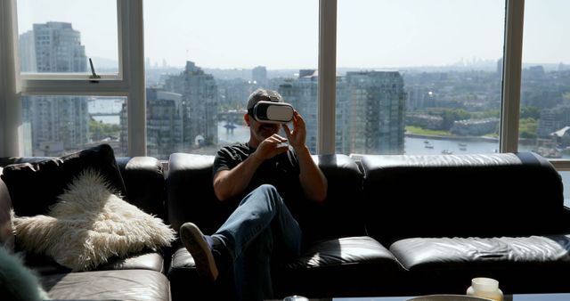 Man using virtual reality headset in modern city apartment - Download Free Stock Images Pikwizard.com