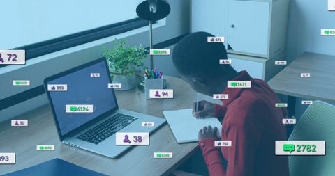 Focused Student Writing at Home Desk with Social Media Notifications