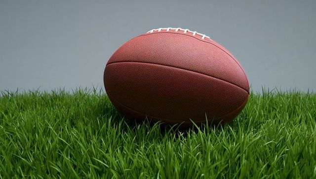 American football on grass with subtle backdrop
