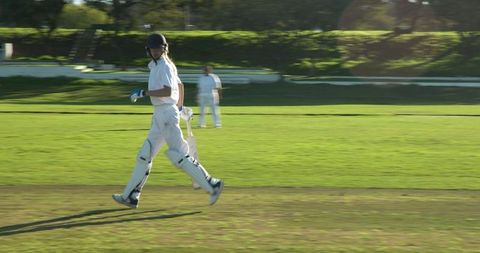 Female Cricketers Practicing Strategy on Sunny Field
