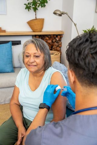 Senior Woman Receiving Vaccine at Home