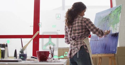 Artist Painting on Canvas in Modern Studio with AR Integration