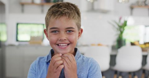 Smiling Young Boy in Bright Kitchen Dining Area - Download Free Stock Images Pikwizard.com