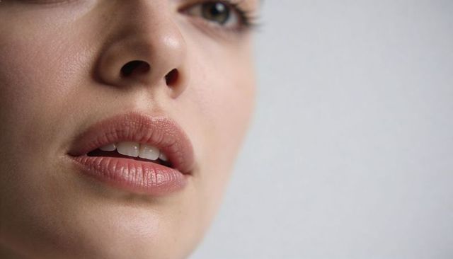 Closeup young woman parted lips smooth skin beauty portrait detail