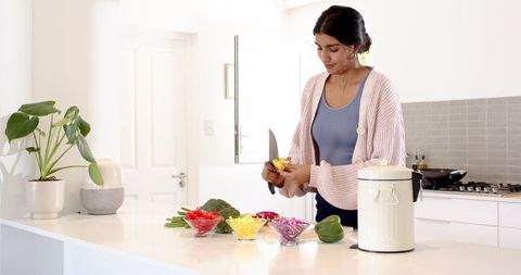 Woman Prepping Vegetables in Modern Minimalist Kitchen