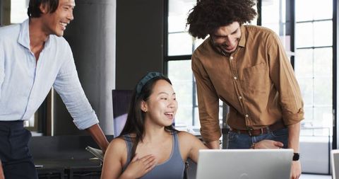 Diverse Colleagues Collaborating Over Laptops