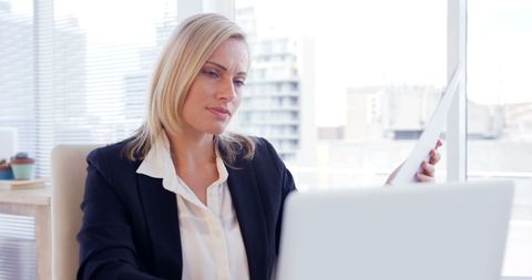 Focused Businesswoman Analyzing Reports in Modern Office - Download Free Stock Images Pikwizard.com
