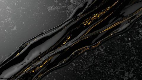 Flowing Viscous Black Liquid with Glowing Gold Veins on Textured Dark Marble Surface