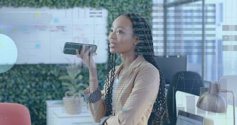 Businesswoman Analyzing Data With Digital Display In Modern Office