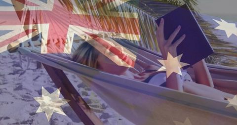 Blonde woman relaxing in hammock reading tablet with australian flag overlay at tropical beach