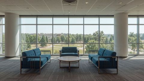 Modern Lounge Seating with Blue Sofas and Large Windows