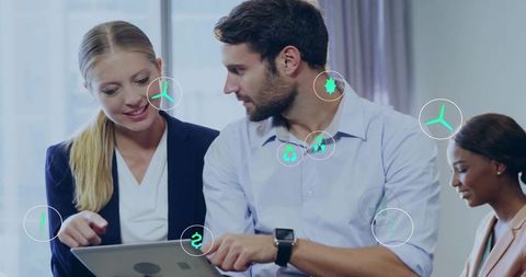 Business team pointing at tablet with ar eco icons for corporate sustainability collaboration
