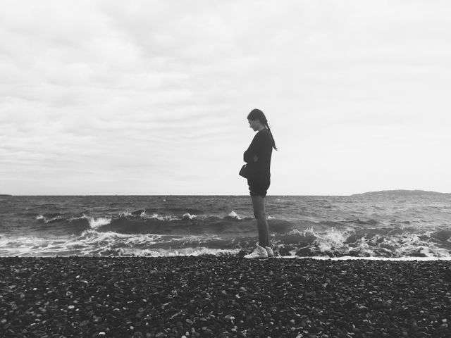 Lonely Person Standing by the Ocean in Black and White - Download Free Stock Photos Pikwizard.com