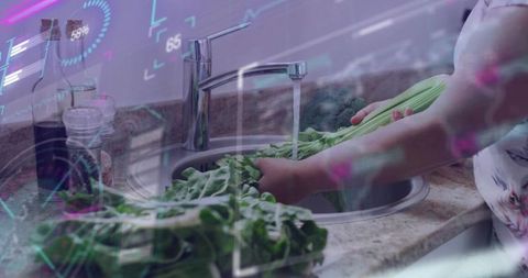 Washing leafy greens at kitchen sink with chrome faucet and holographic ui overlay