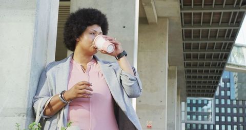 Stylish Plus Size Woman Enjoying Coffee in Urban Environment