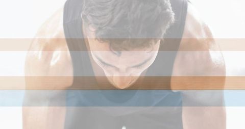 Lean athlete breathing deep in high-key studio with horizontal bands for workout intensity