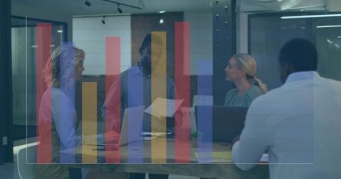 Team reviewing data and reports around glass conference table with bar chart overlay
