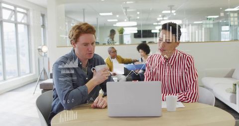 Colleagues Analyzing Data and Reports in Modern Office