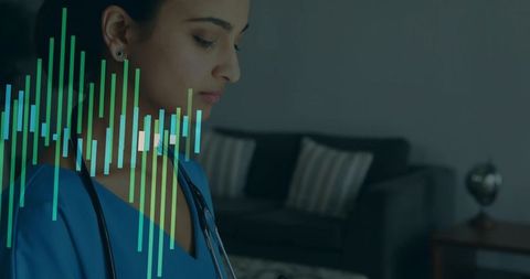 Indian clinician in blue scrubs using tablet with teal data waveform overlay in lounge