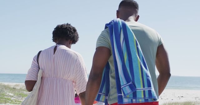 Couple Walking to Beach with Towels on Sunny Day - Download Free Stock Images Pikwizard.com