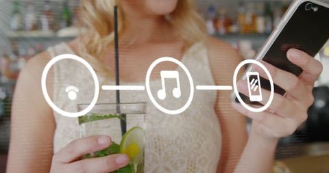 Woman Enjoying Refreshing Drink While Browsing Phone