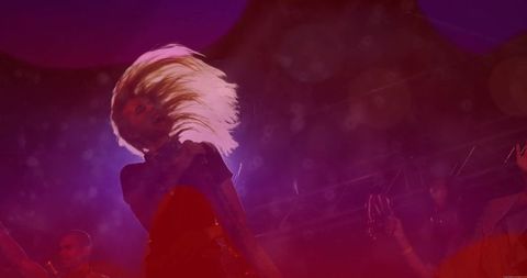 Dynamic Performer with Blonde Hair on Vibrant Music Stage